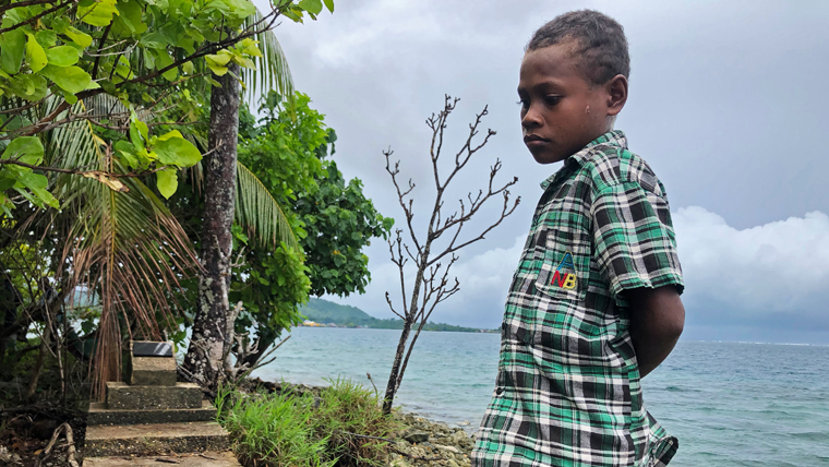Timothy, 13, visiting his family's old home in the Solomon Islands