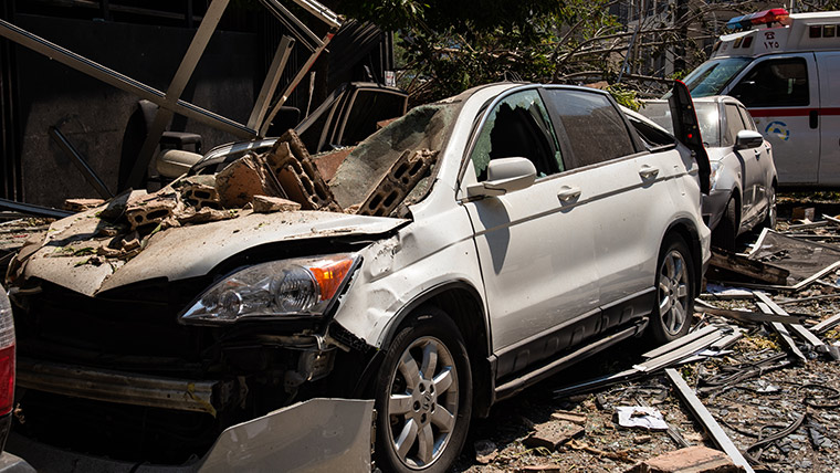 A car crushed by falling debris, following the enormous explosion at Beirut's port