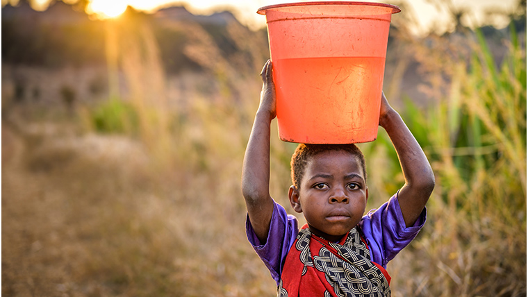 Ireen, 8, carries the precious water home