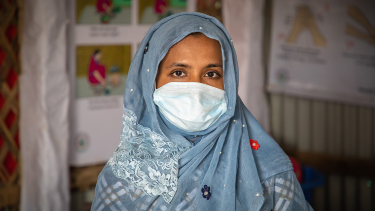 Fatema, wears a protective face mask as she meets with her fellow Rohingya mothers
